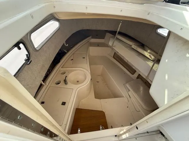 Slide: The Image of Interior of 2002 Grady-White 232 Gulfstream boat, featuring compact cabin layout. - 9