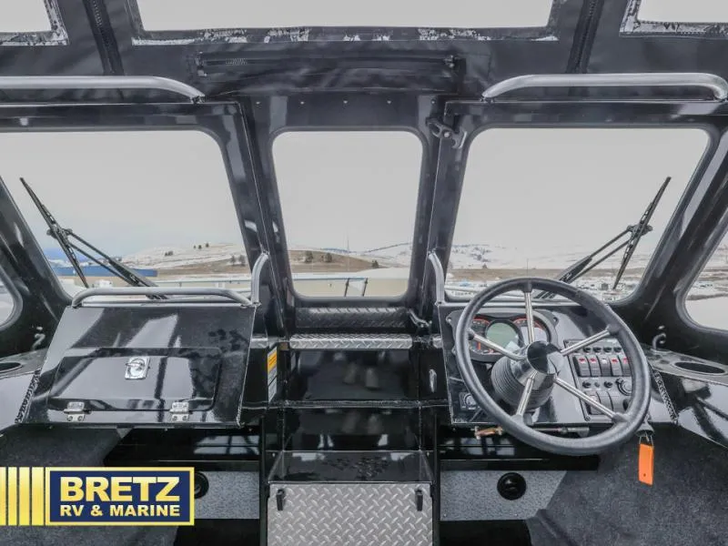 Slide: The Image of 2025 River Runner 180 boat cockpit with steering wheel and dashboard controls. - 11