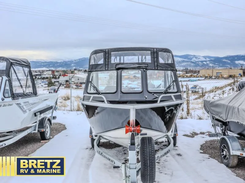 Slide: The Image of 2025 River Runner 180 boat on trailer in snowy landscape at Bretz RV & Marine. - 2
