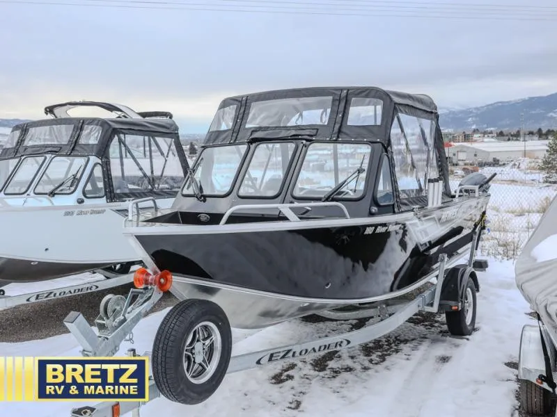 Slide: The Image of 2025 River Runner 180 boat on EZ Loader trailer in snowy landscape. - 3