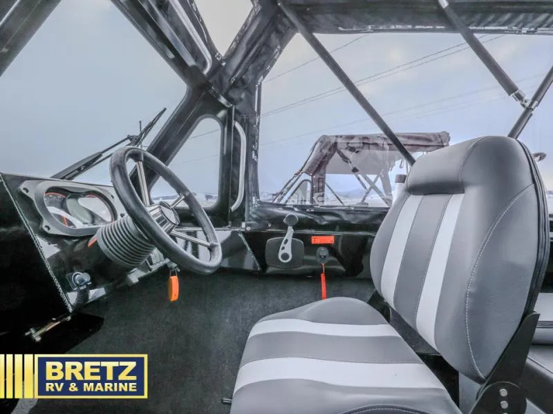 Slide: The Image of Interior of 2025 River Runner 180 boat with steering wheel and seat. - 9