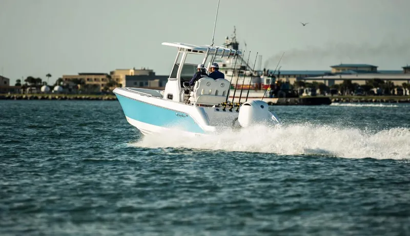 Slide: The Image of 2025 Edgewater 230CC boat cruising on open water. - 1