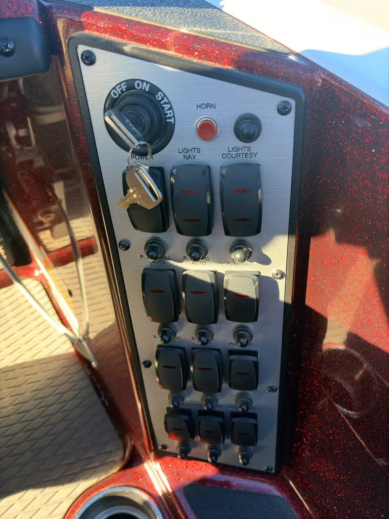 Slide: The Image of Control panel of 2023 Caymas CX 18 SS boat with switches and ignition. - 11