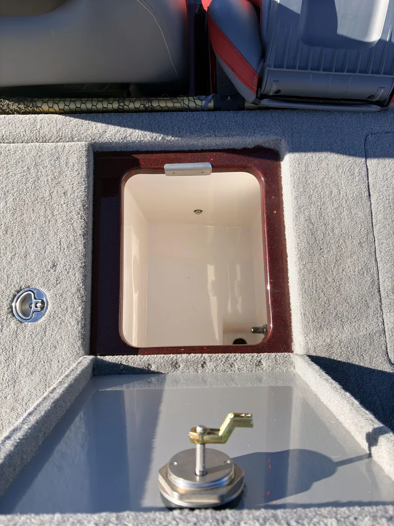 Slide: The Image of 2023 Caymas CX 18 SS boat storage compartment with latch and seating. - 12