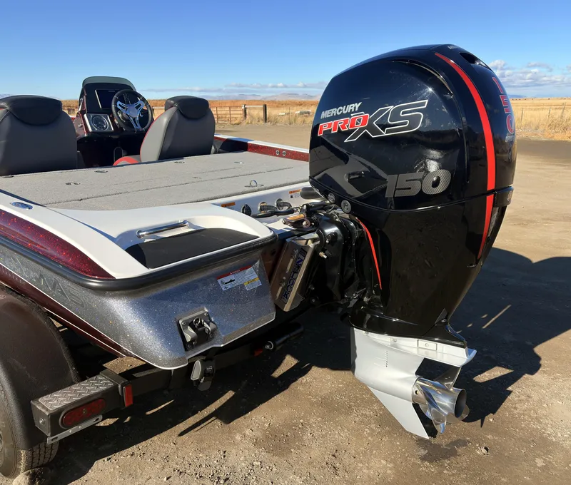 Slide: The Image of 2023 Caymas CX 18 SS boat with Mercury Pro XS 150 engine, parked outdoors. - 14