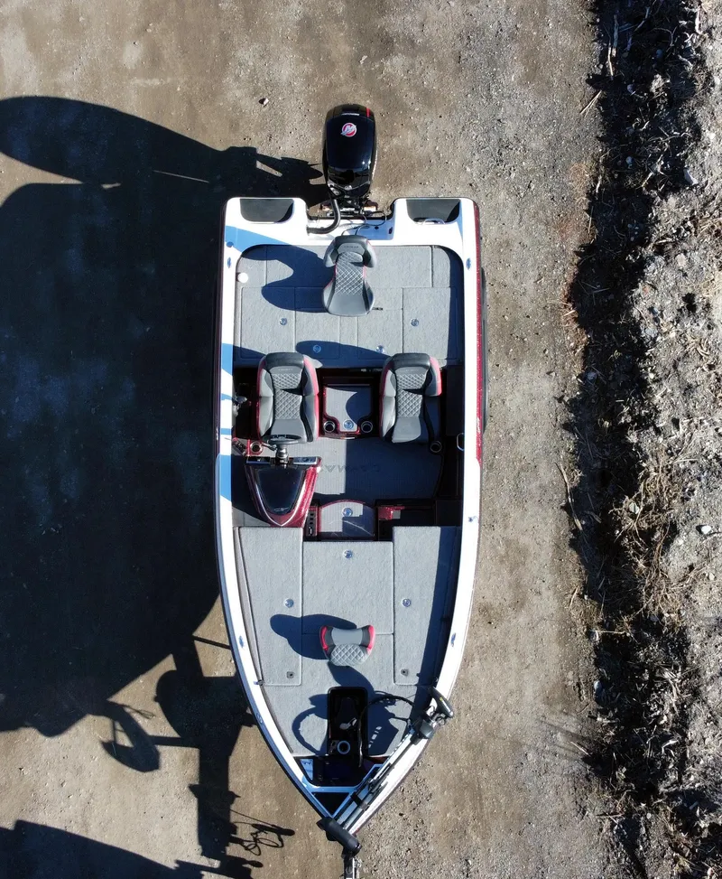 Slide: The Image of 2023 Caymas CX 18 SS boat, aerial view, parked on a dirt surface. - 3