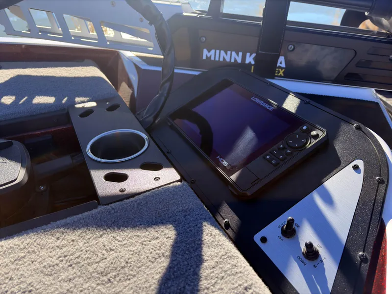 Slide: The Image of 2023 Caymas CX 18 SS boat dashboard with Lowrance fishfinder and Minn Kota trolling motor. - 9