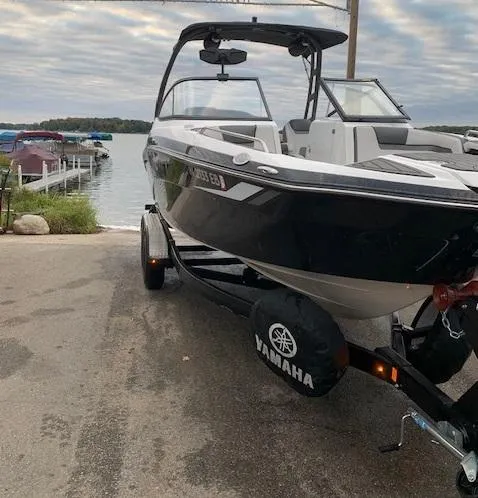 Slide: The Image of 2018 Yamaha AR 240 boat on trailer by a lake, ready for launch. - 2