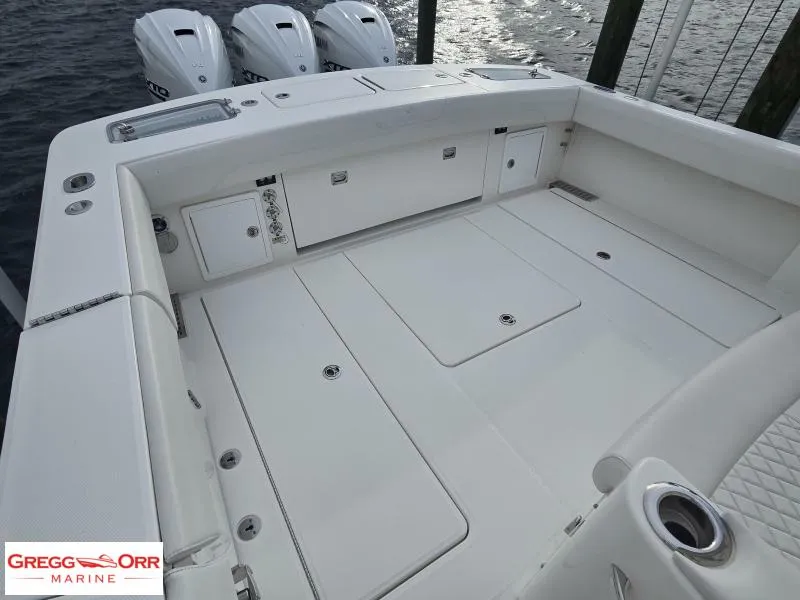 Slide: The Image of 2024 Regulator 37 boat deck with triple outboard engines, spacious layout, and storage compartments. - 13