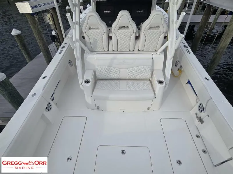 Slide: The Image of 2024 Regulator 37 boat interior with white seating and marine equipment. - 16