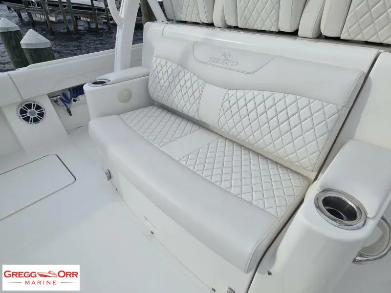 Slide: The Image of 2024 Regulator 37 boat with luxurious white quilted seating and cup holders. - 17