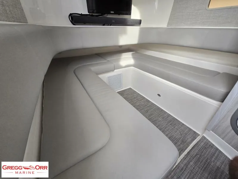 Slide: The Image of 2024 Regulator 37 cabin interior with cushioned seating and TV, showcasing modern marine design. - 20