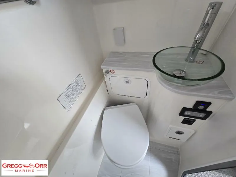 Slide: The Image of 2024 Regulator 37 boat bathroom with modern sink and toilet, Gregg Orr Marine branding. - 24
