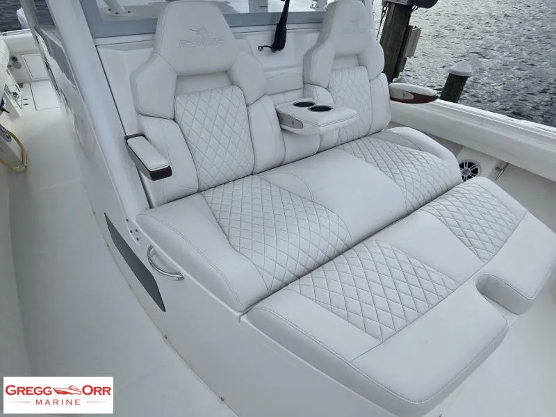 Slide: The Image of Luxurious seating on 2024 Regulator 37 boat with diamond-stitched upholstery and cup holders. - 4