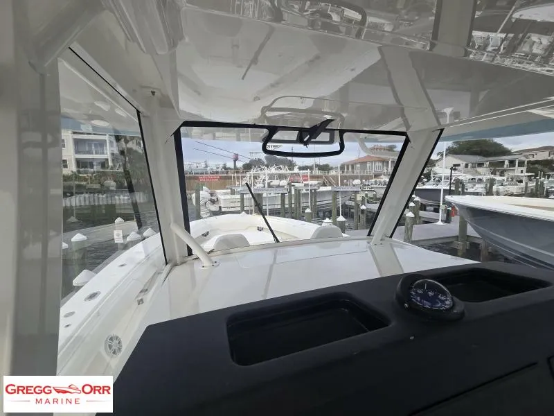 Slide: The Image of 2024 Regulator 37 boat interior view with compass, docked at marina. - 9