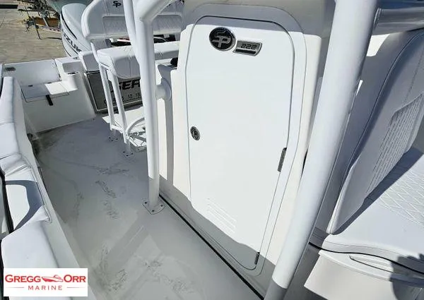 Slide: The Image of 2024 Sea Pro 222 CC boat interior with seating and storage compartment. - 14