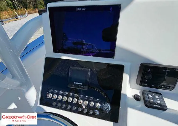 Slide: The Image of 2024 Sea Pro 222 CC boat dashboard with Simrad display and Suzuki controls. - 18