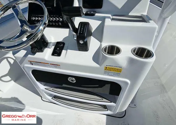 Slide: The Image of 2024 Sea Pro 222 CC boat console with steering wheel and cup holders. - 19