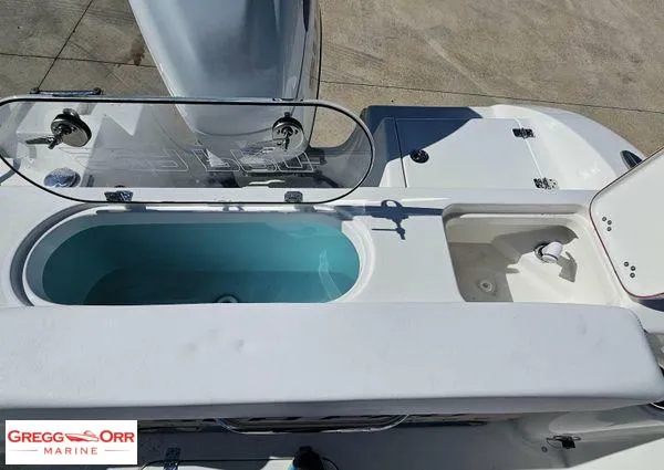 Slide: The Image of 2024 Sea Pro 222 CC boat deck with livewell and storage compartments. - 23