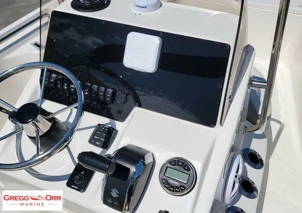 Slide: The Image of 2024 Bulls Bay 2200 boat dashboard with steering wheel and control panel. - 12
