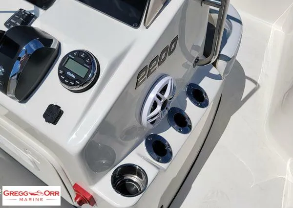 Slide: The Image of 2024 Bulls Bay 2200 boat console with controls, cup holders, and speaker. - 13