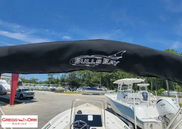 Slide: The Image of 2024 Bulls Bay 2200 boat at Gregg Orr Marine dealership, clear sky background. - 18