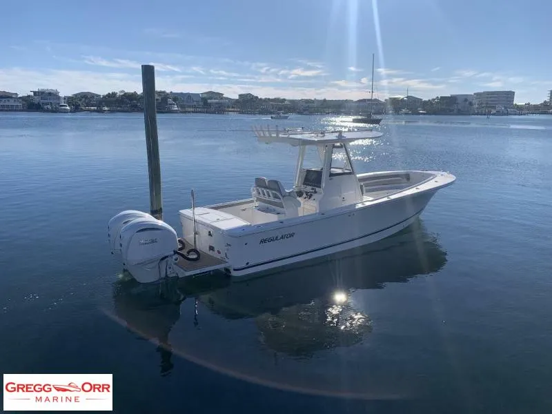 Slide: The Image of 2025 Regulator 28 boat docked on calm water under clear sky. - 3