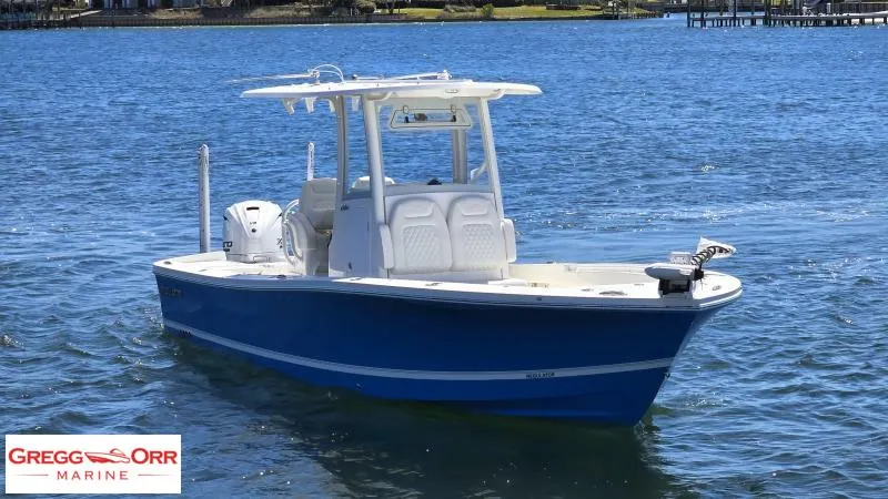 Slide: The Image of 2025 Regulator 26XO CROSSOVER boat on water, featuring a sleek blue design. - 1