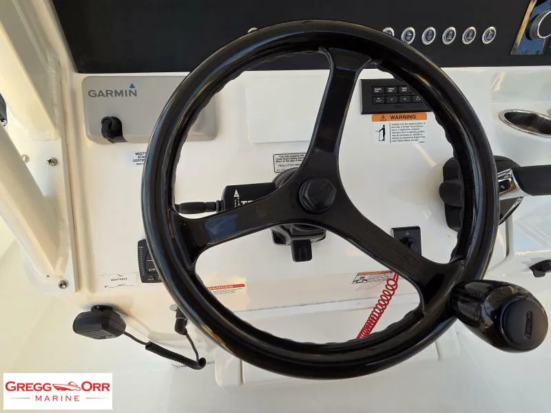 Slide: The Image of Steering wheel of 2025 Regulator 26XO CROSSOVER boat with Garmin controls. - 13