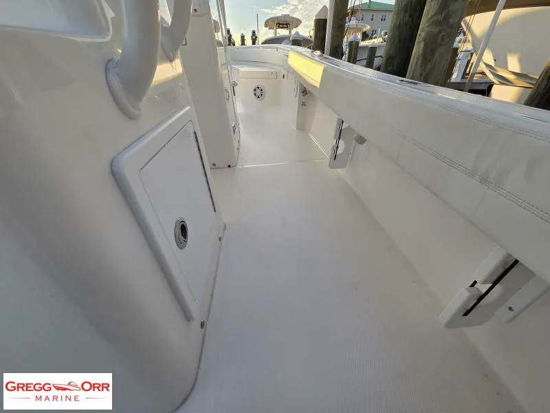 Slide: The Image of 2025 Regulator 26XO Crossover boat interior, featuring sleek white design and spacious layout. - 16