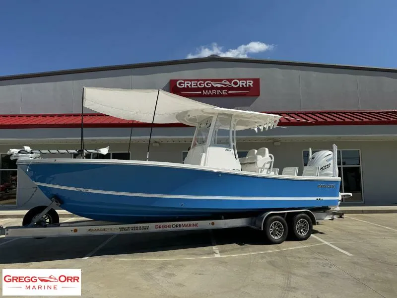 Slide: The Image of 2025 Regulator 26XO Crossover boat on trailer at Gregg Orr Marine dealership. - 4