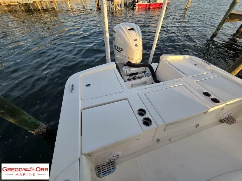 Slide: The Image of 2025 Regulator 26XO CROSSOVER boat with V8 engine, docked on calm water. - 5