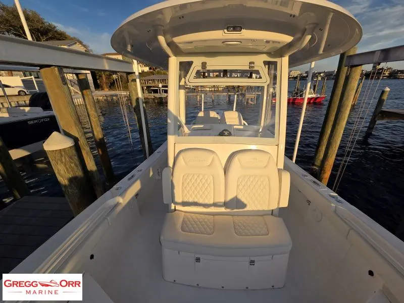 Slide: The Image of 2025 Regulator 26XO Crossover boat docked at marina, showcasing seating and helm. - 9