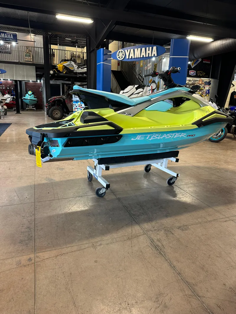 Slide: The Image of 2025 Yamaha WaveRunner JetBlaster PRO 2-Up in showroom, vibrant yellow and teal design. - 10