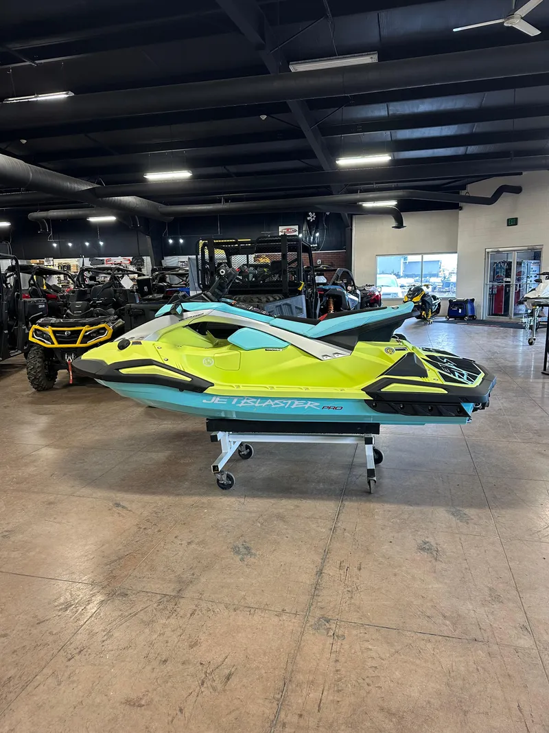 Slide: The Image of 2025 Yamaha WaveRunner JetBlaster PRO 2-Up in showroom, vibrant yellow and blue design. - 8