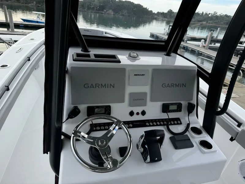 Slide: The Image of 2023 Front Runner 33 Center Console boat dashboard with Garmin displays. - 21