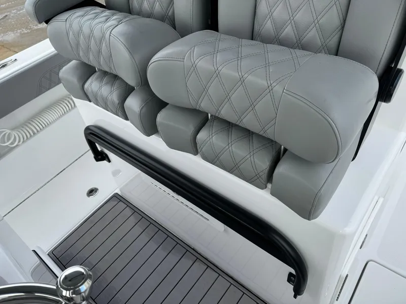 Slide: The Image of 2023 Front Runner 33 Center Console with luxurious gray seating and diamond stitching. - 22