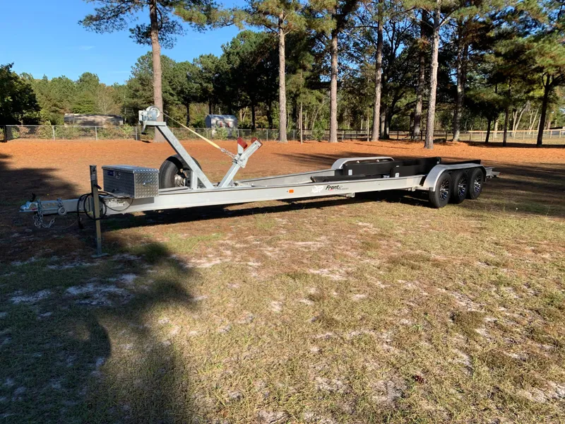 Slide: The Image of Boat trailer for 2023 Front Runner 33 Center Console in a wooded area. - 36