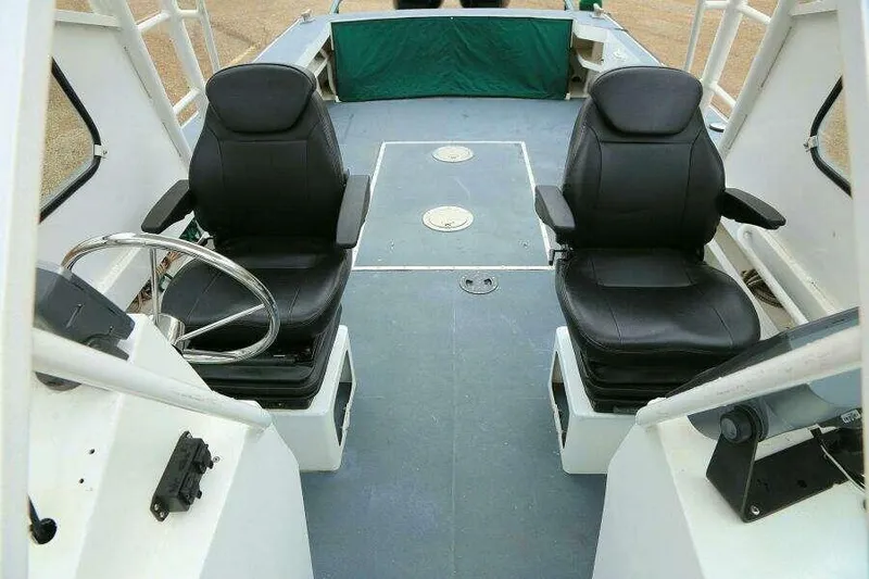 Slide: The Image of Interior of 2002 SeaArk 25 V Commander SAMA 1365 boat with dual black seats. - 10