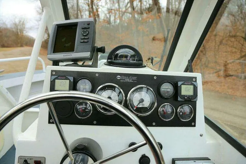 Slide: The Image of Control panel of a 2002 SeaArk 25 V Commander SAMA 1365 boat with gauges and navigation equipment. - 11