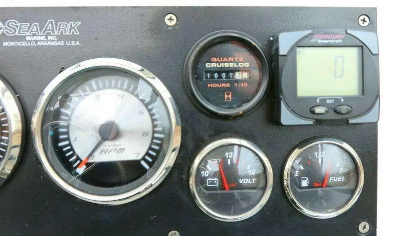 Slide: The Image of SeaArk 25 V Commander SAMA 1365 dashboard with RPM, volt, and fuel gauges, 2002 model. - 12