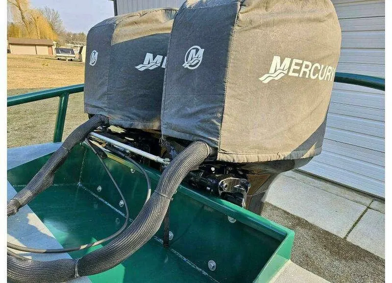 Slide: The Image of Twin Mercury outboard motors on a 2002 SeaArk 25 V Commander SAMA 1365 boat. - 17