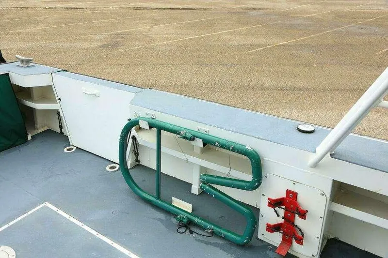 Slide: The Image of SeaArk 25 V Commander SAMA 1365 boat deck, 2002 model, featuring green railing and storage compartments. - 19