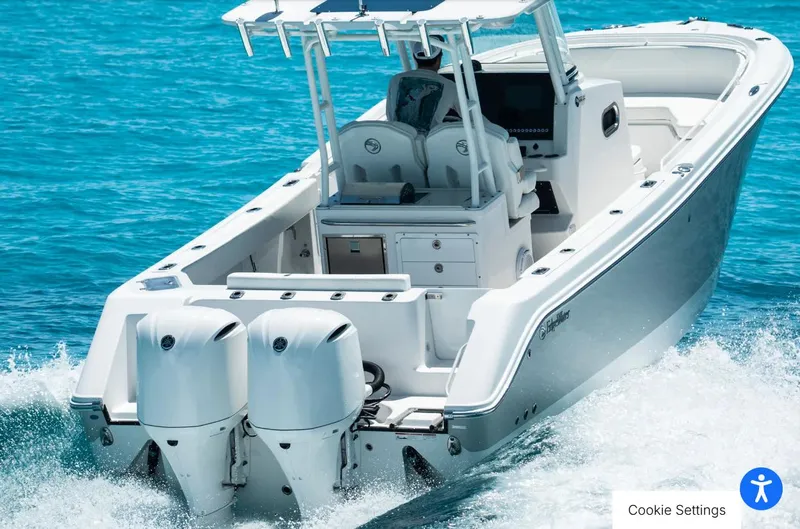 Slide: The Image of 2025 Edgewater 285CC boat cruising on clear blue water. - 1