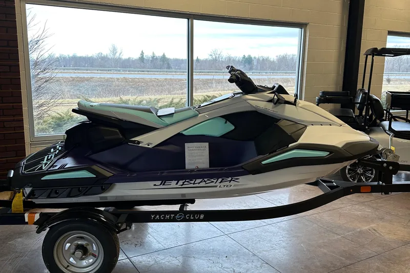 Slide: The Image of 2025 Yamaha WaveRunner JetBlaster LTD on trailer in showroom setting. - 11