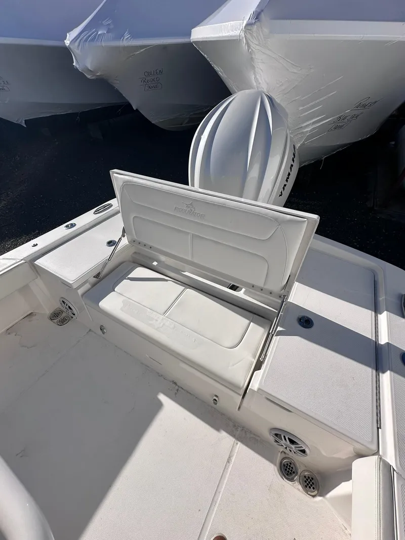 Slide: The Image of 2024 Regulator 24XO boat interior with open storage compartment. - 11