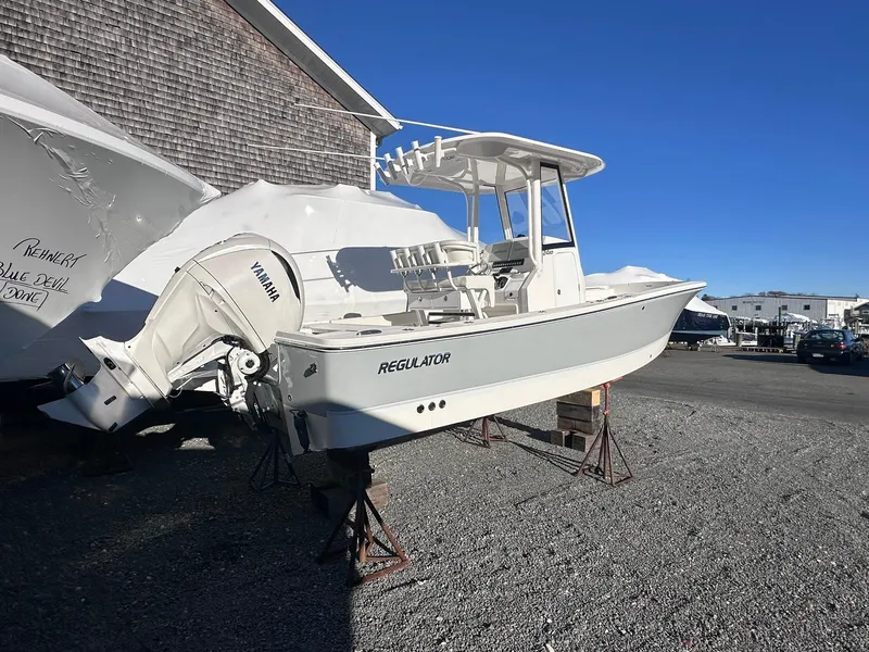 Slide: The Image of 2024 Regulator 24XO boat with Yamaha engine on display outdoors. - 2