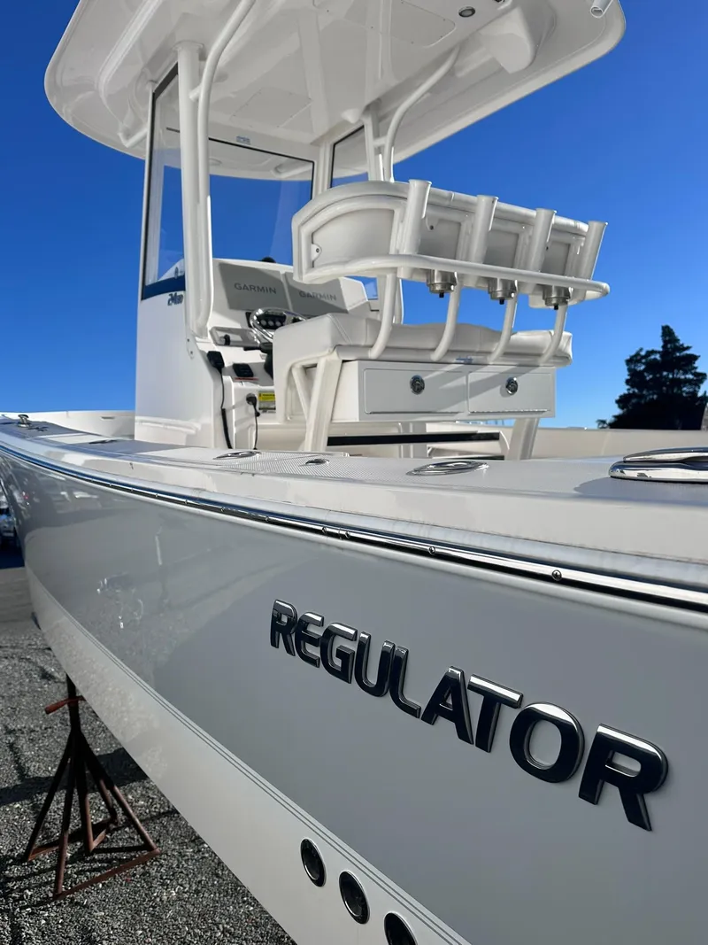 Slide: The Image of 2024 Regulator 24XO boat, sleek design, white exterior, clear blue sky background. - 6