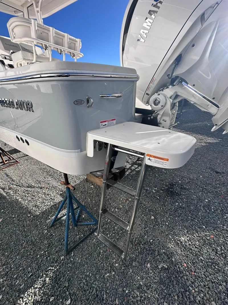 Slide: The Image of 2024 Regulator 24XO boat with ladder and Yamaha engine, displayed on gravel. - 8
