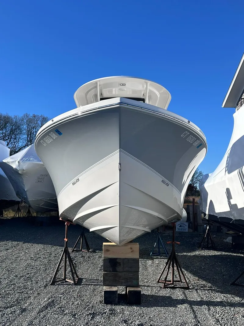 Slide: The Image of 2024 Regulator 24XO boat on stands, front view, clear blue sky. - 9